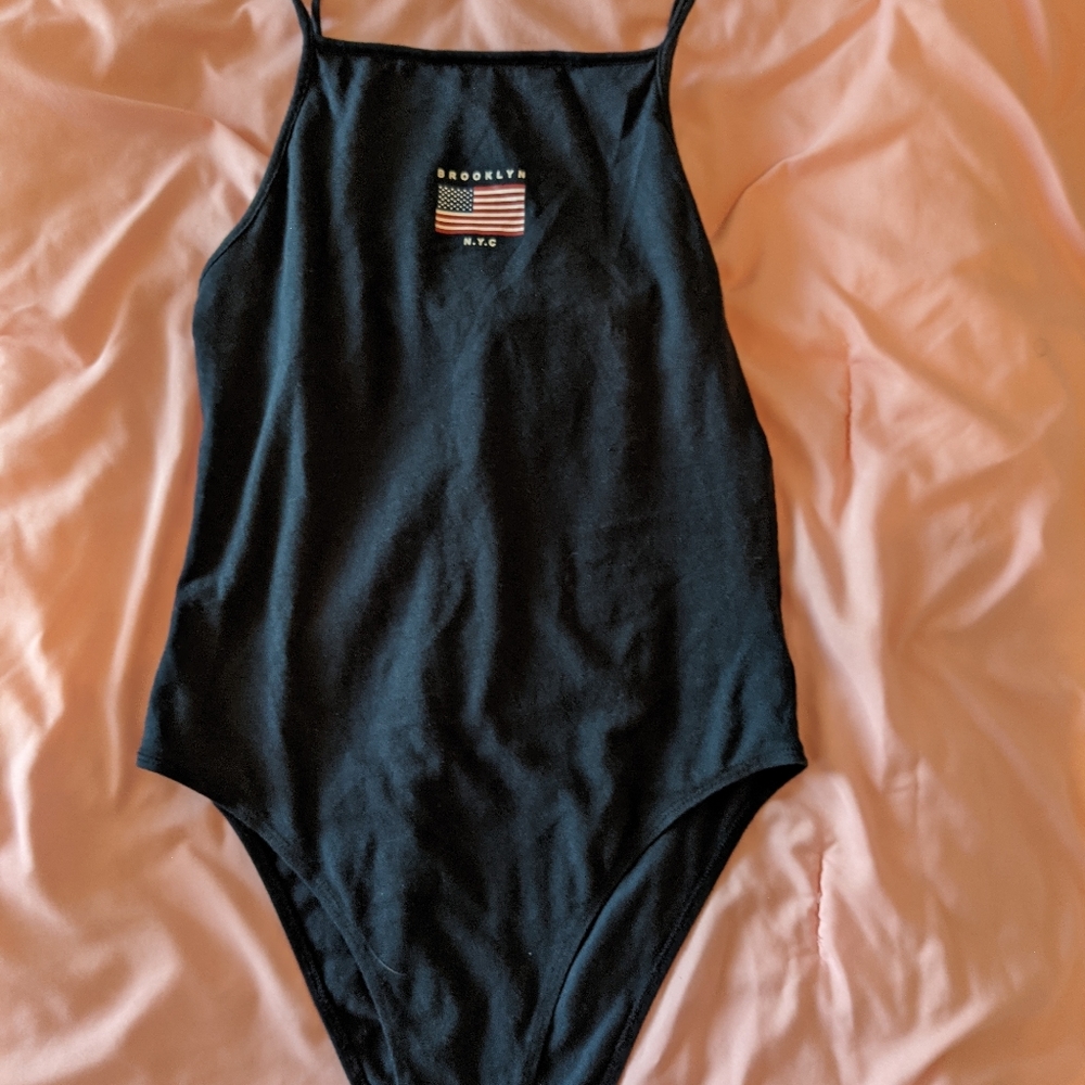 Blue onesie shirt. Brooklyn nyc with american flag